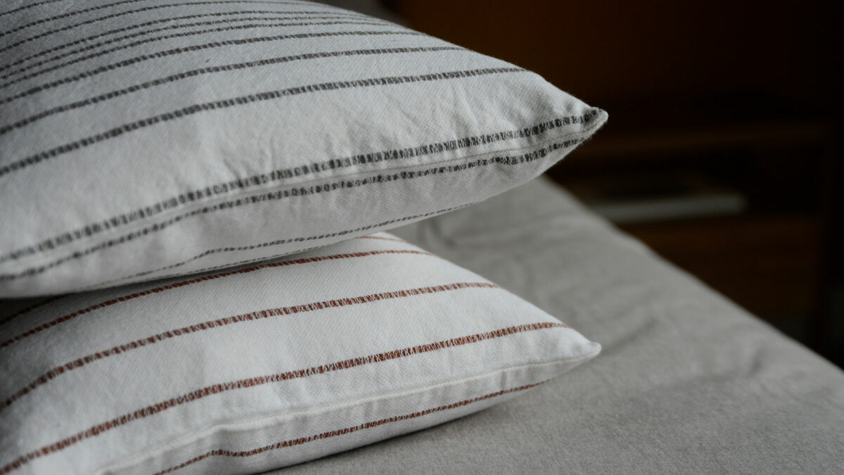 Jacquard weave white cotton cushions with stripe in charcoal or terracotta