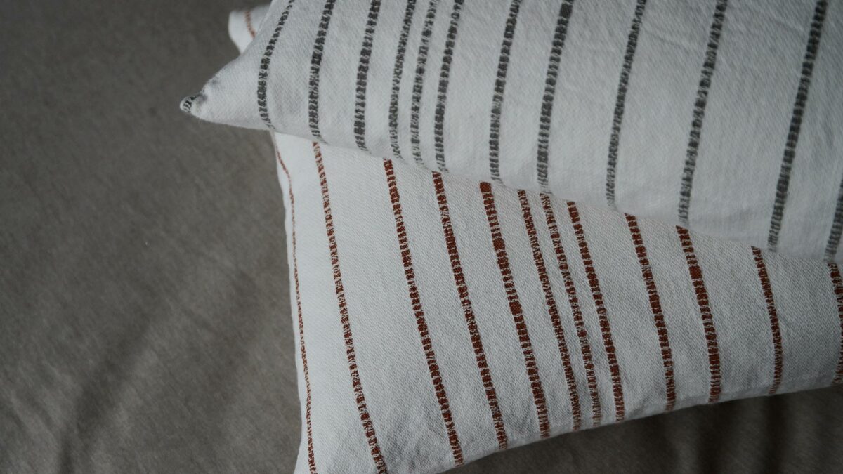 Jacquard weave white cotton cushions with stripe in charcoal or terracotta