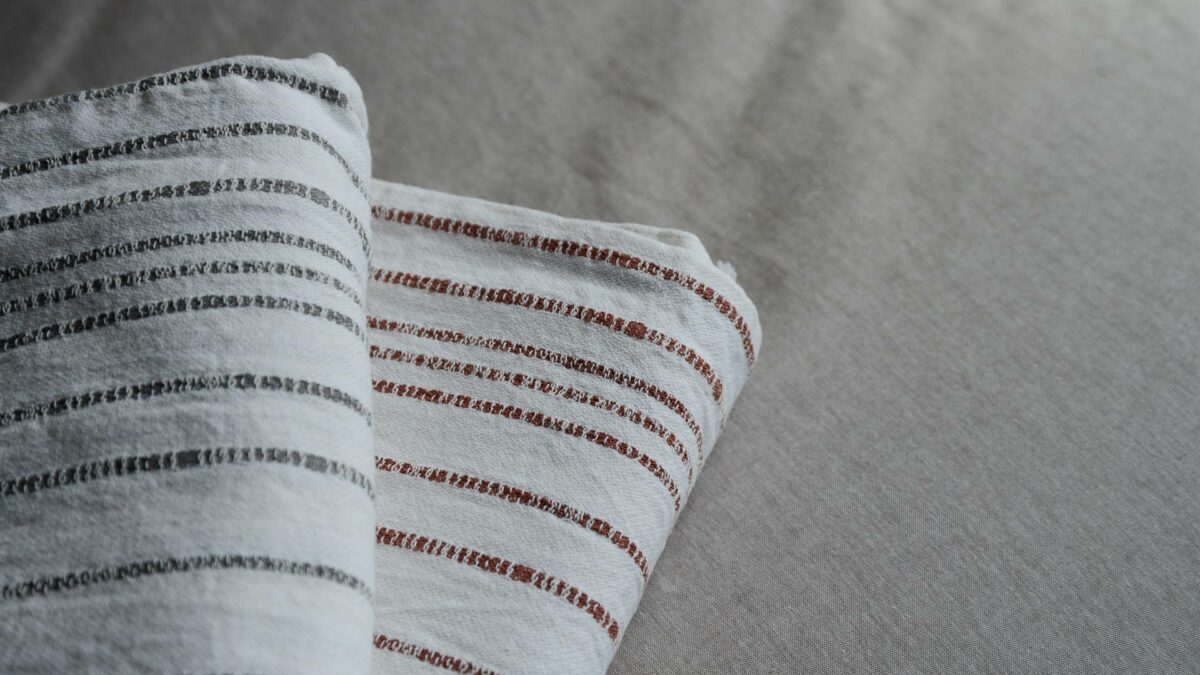 Jacquard weave white cotton throws with stripes in charcoal or terracotta