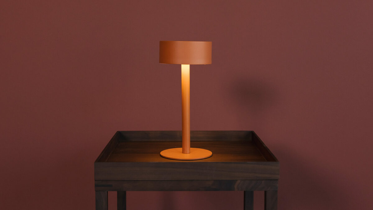 adjustable orange bedside lamp lit