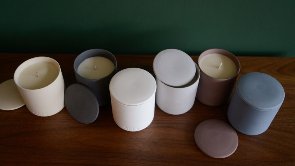 luxury gift-boxed scented candles in matt clay pots with lids in a range of scents and colours