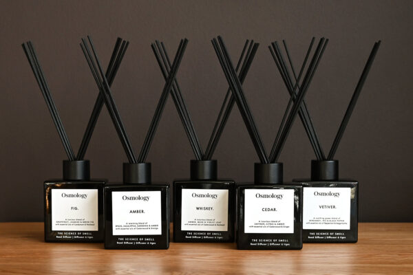 Five Aery Osmology diffusers lined up next to each other, in the scents Fig, Amber, Whiskey, Cedar and Vetiver.