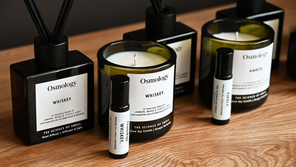 A close up image of the Aery diffusers, roll-on perfume oils and candles in the Whiskey and Amber scents.