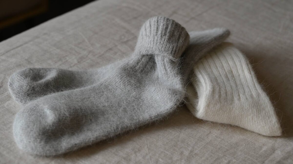 2 pairs of Angora blend socks with rib top. One pair ivory, the other grey.
