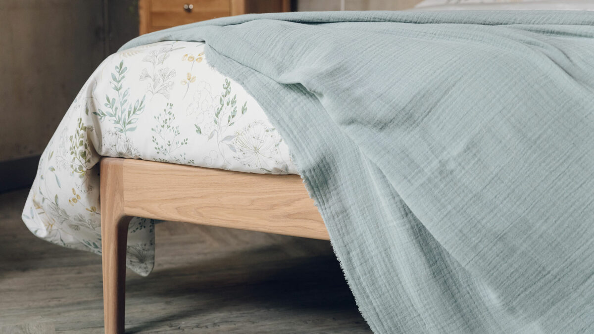 muted aqua colour crinkled bedspread shown in close up