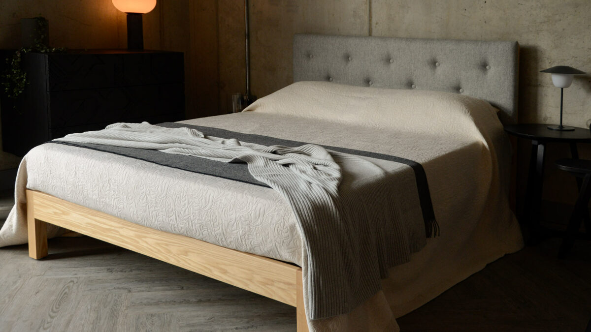 aran bed with stone bedspread and knitted throws