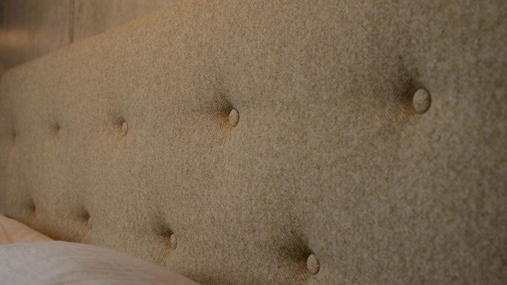 a closer view of the buttoned wool fabric Arran bed headboard