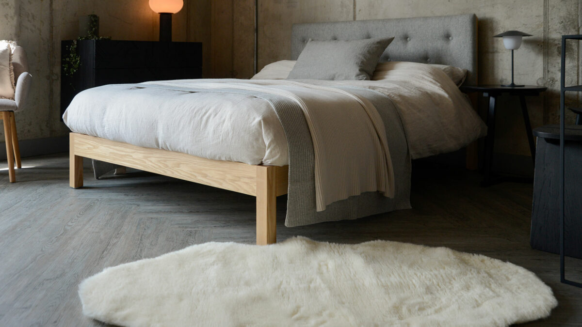 ash Arran bed with grey headboard and faux sheepskin rug 1250