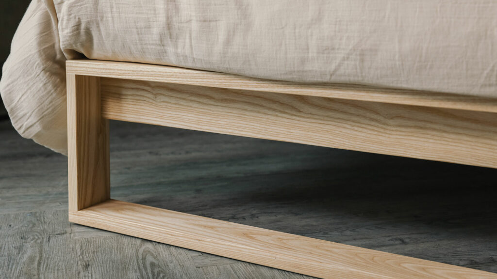 A special edition Leith bed in Ash wood a close up of the foot end