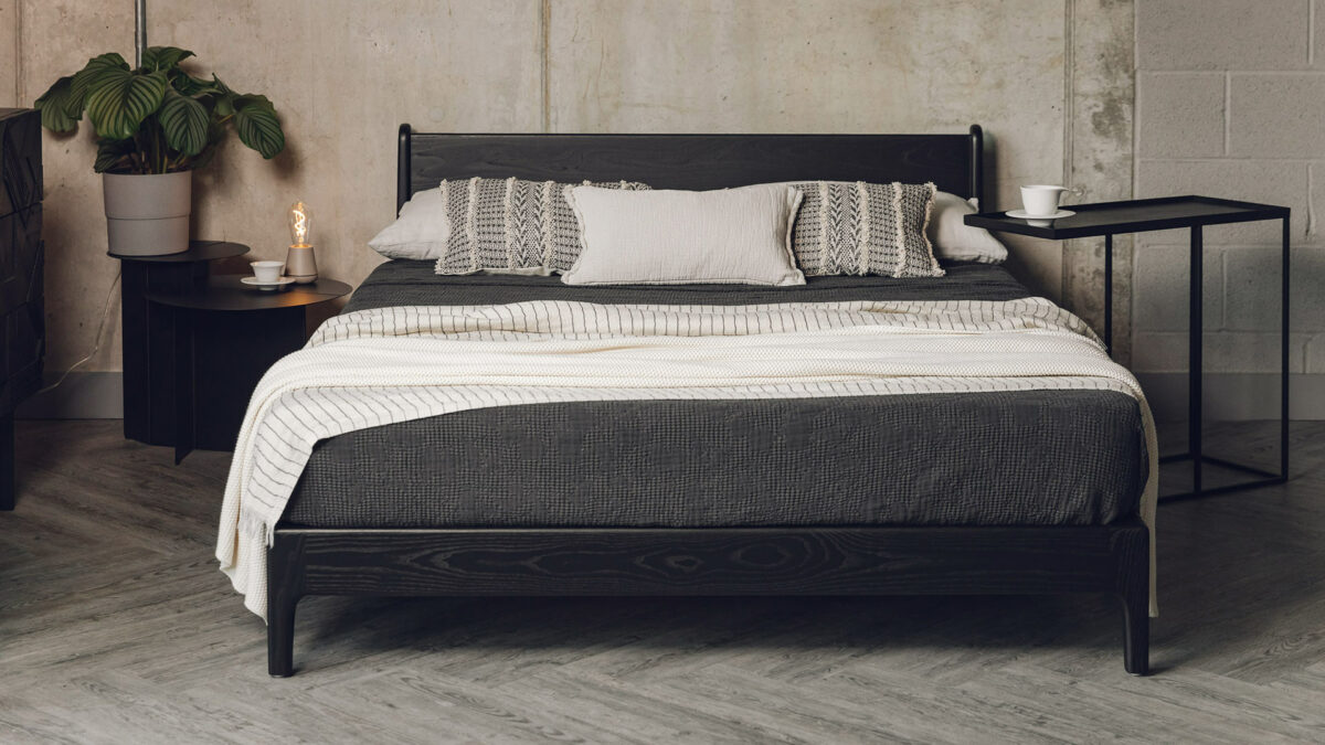 The Pimlico low bed here is made from black stained solid Ash wood and is shown with monochrome bedding