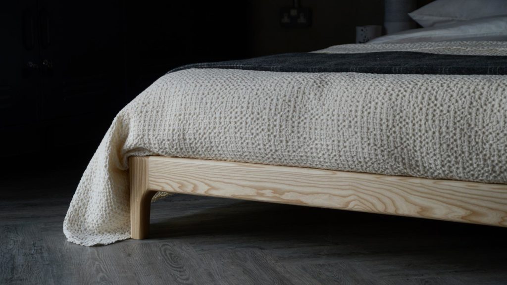 A close-up view of the Carnaby low bed foot end, here made from solid ash