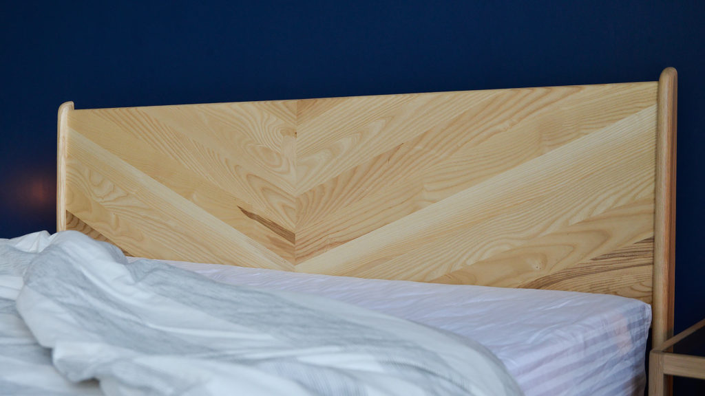 A close view of the chevron pattern Hoxton headboard hand-made from sustainably sourced solid wood.