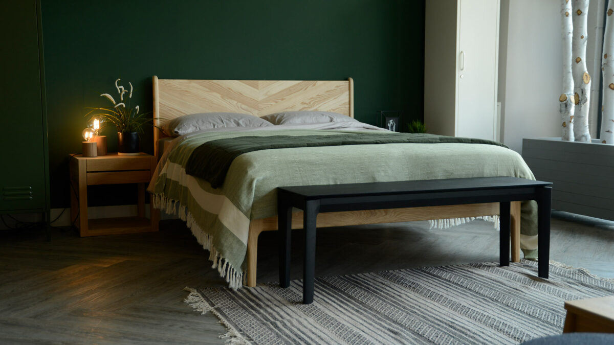 black painted solid oak bench or end of bed table shown in a bedroom setting