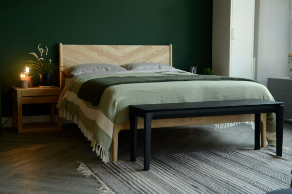 black painted solid oak bench or end of bed table shown in a bedroom setting