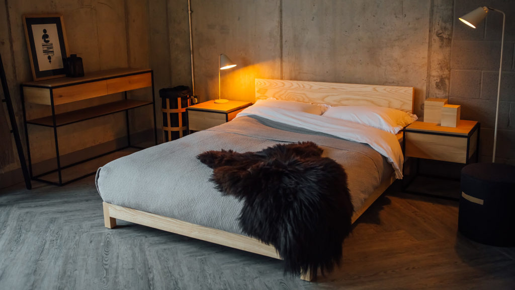 Scandinavian bedroom style with our low wooden Sonora bed in Ash and with sheepskin throw