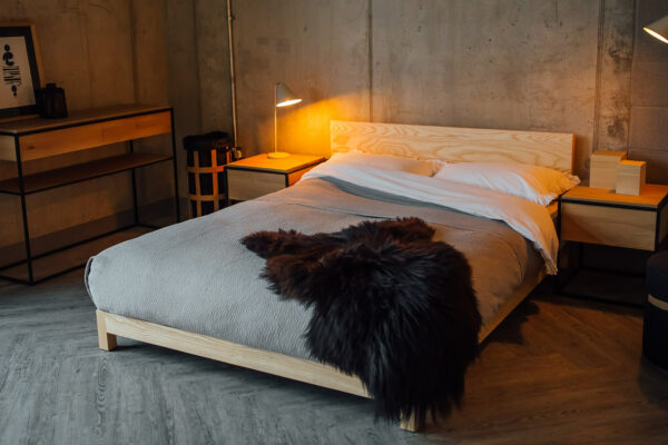 Scandinavian bedroom style with our low wooden Sonora bed in Ash and with sheepskin throw