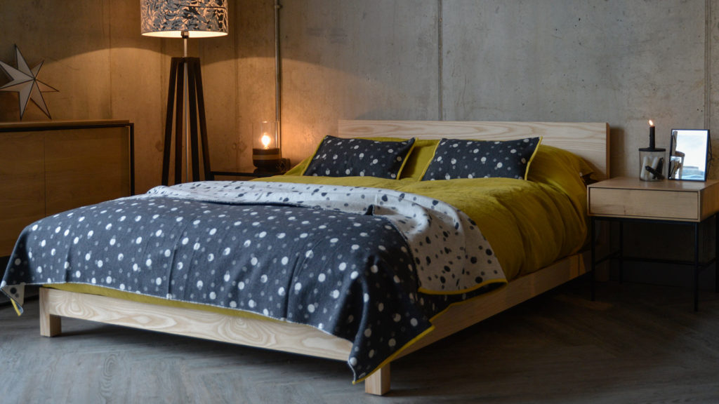 Cosy loft style bedroom featuring our low Ash Sonora bed hand made in UK