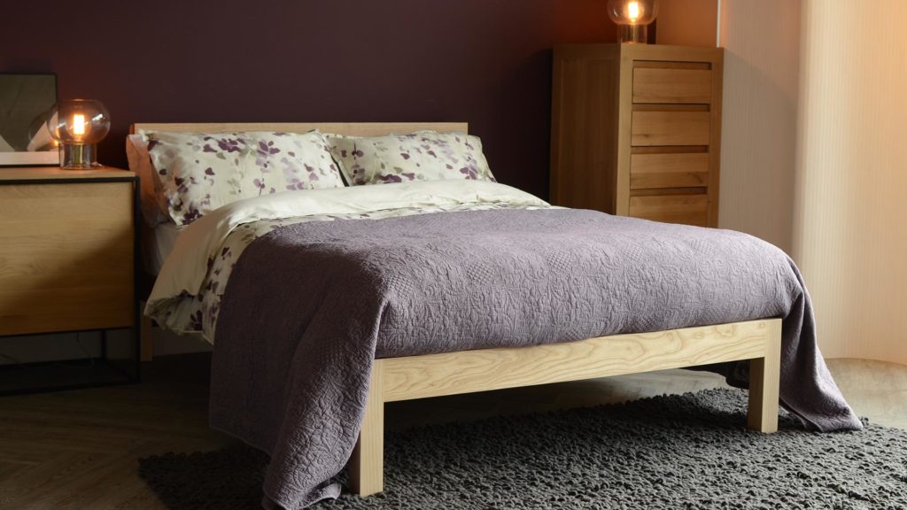 Ash Tibet solid wood hand-made bed shown with mauve and cream bedding