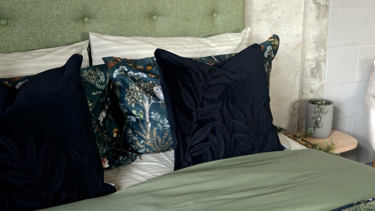 black velvet cushion with black embroidered leaves design