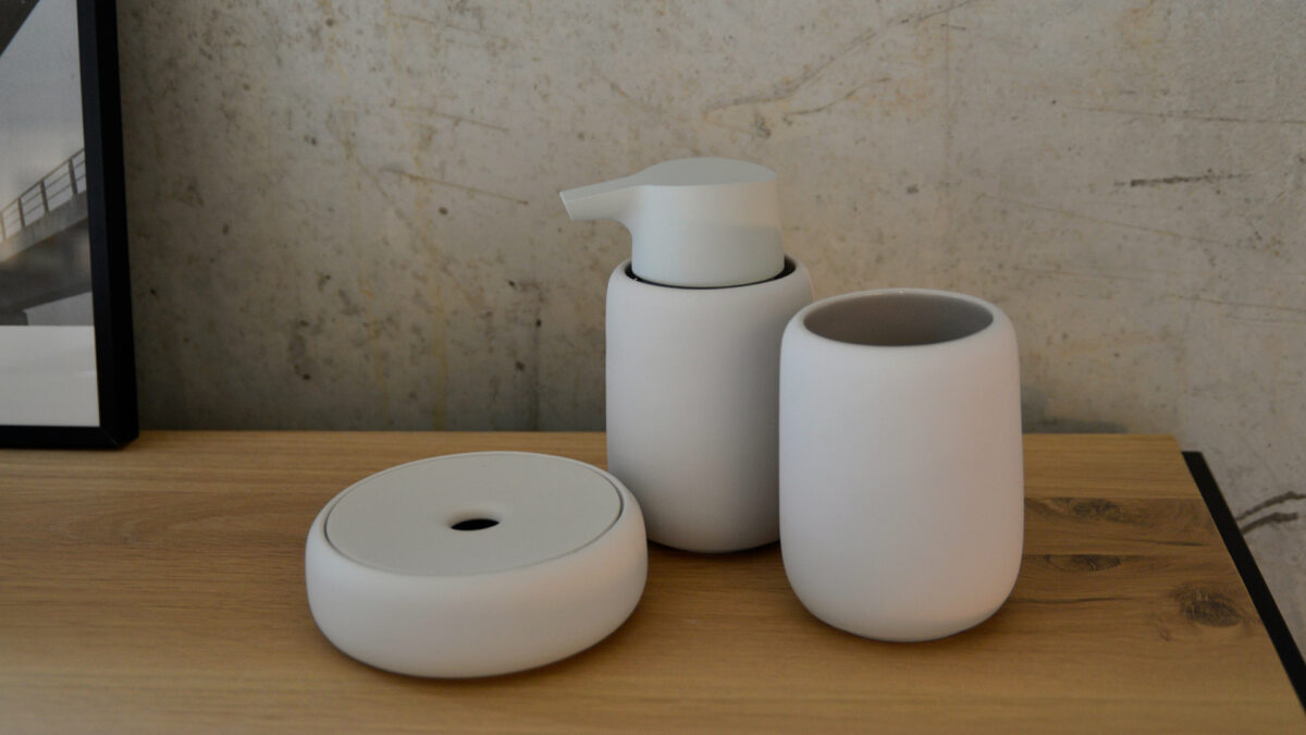 soft touch bathroom accessories in pale clay colour including soap dispenser and storage jar