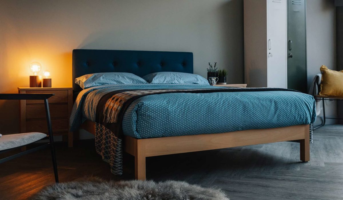 beech Arran bed with teal headboard and beding