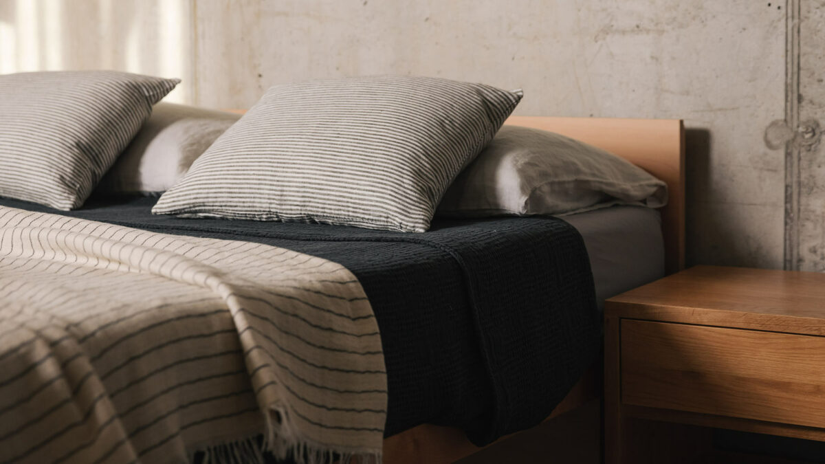 A beech wood Kyoto Japanese style bed shown with an Oak bedside table