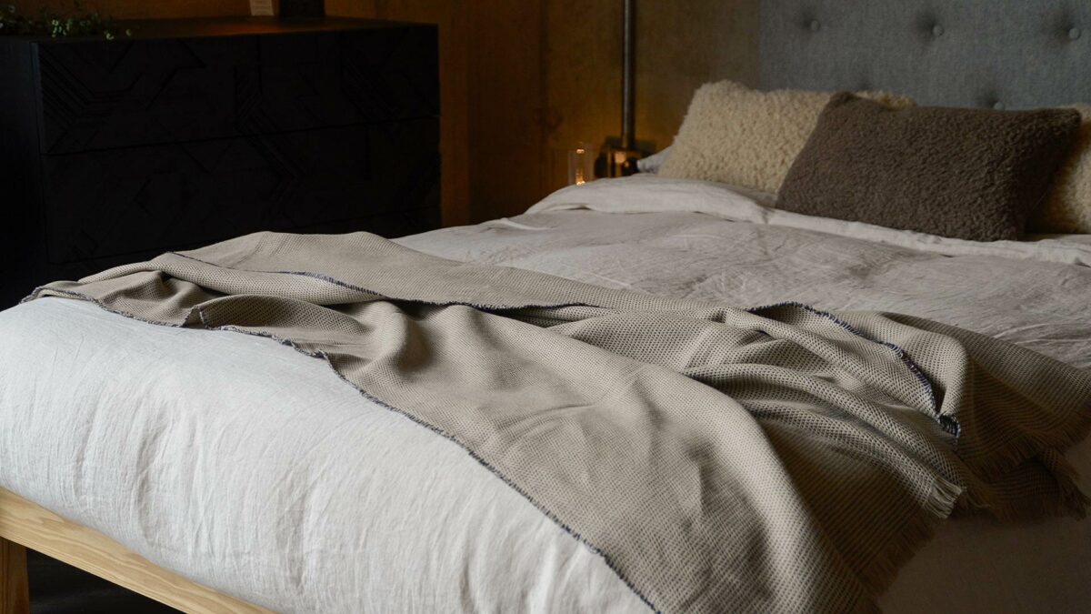 woven beige linen blanket with inky purple threads detail