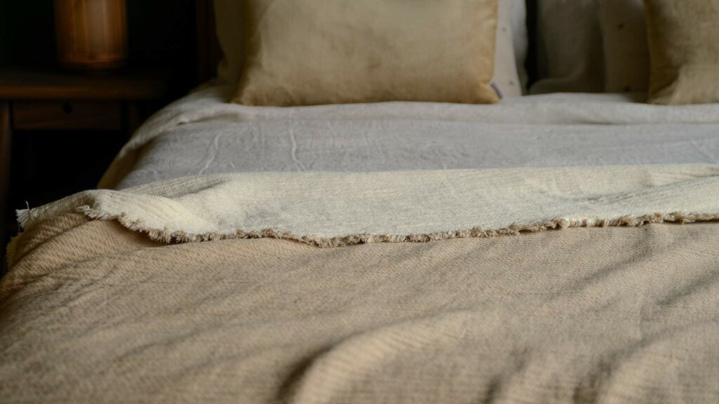 organic cotton reversible throw in beige and ivory