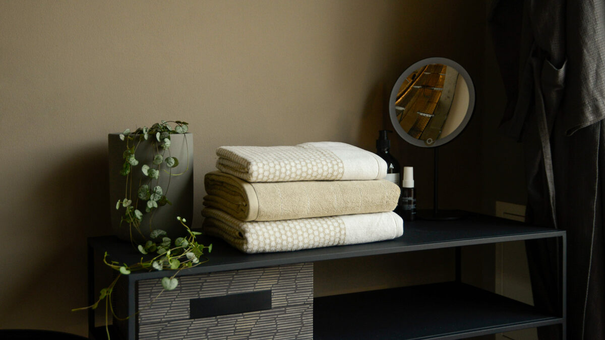beige and white grid or tike towel stack side view
