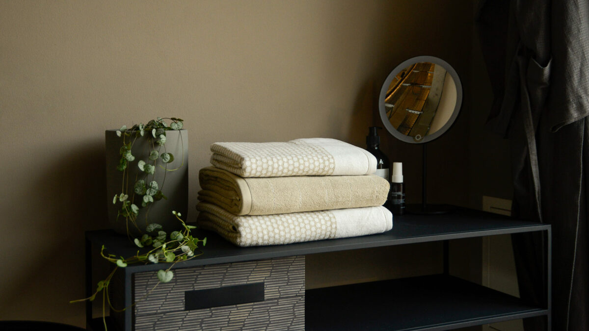 patterned towels in sandstone and white shown folded