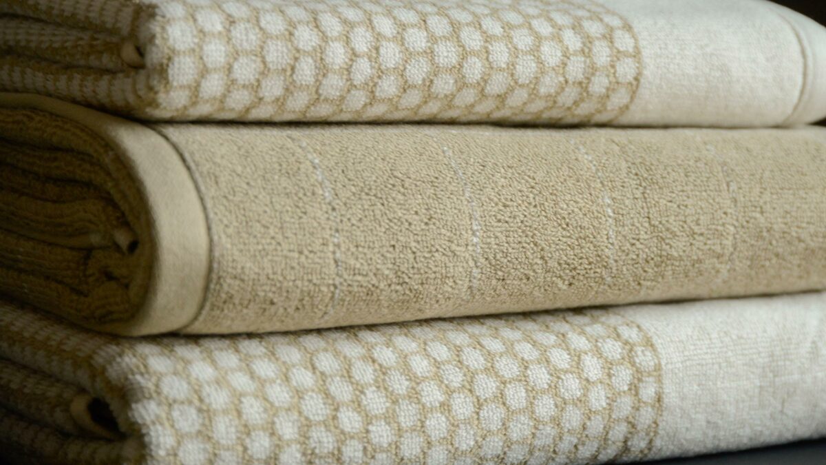 patterned towels in beige and white shown close up