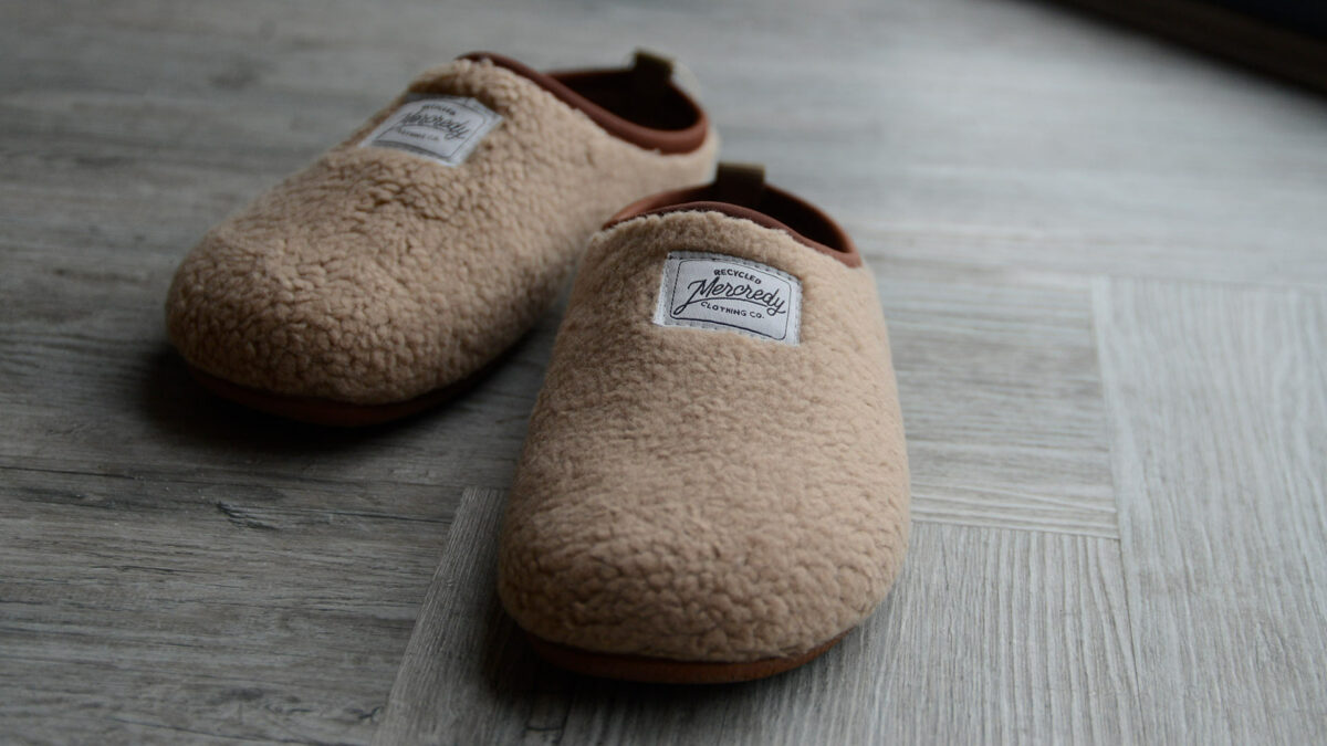 beige sheepskin look slippers with a sole sustainably made from recycled bottles