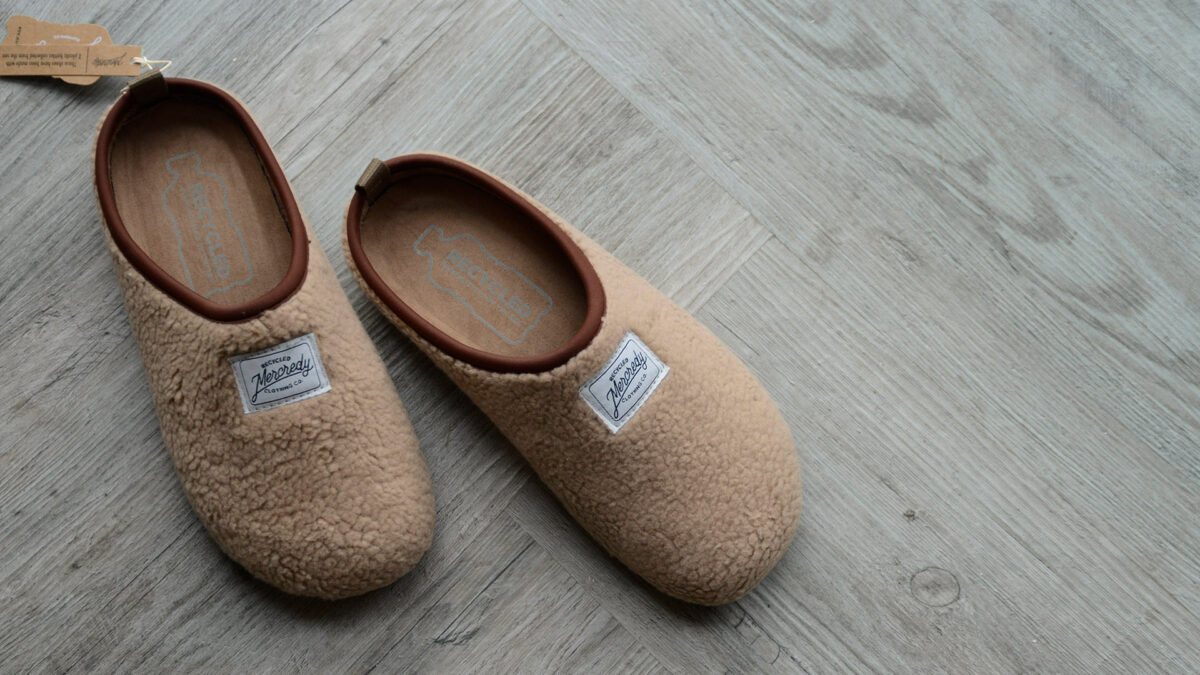 beige sheepskin look slippers with a sole sustainably made from recycled bottles