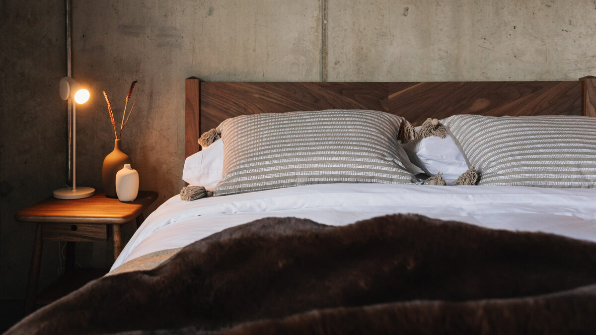 the Dalston bed has a chevron pattern to the solid wood headboard which here is in walnut wood