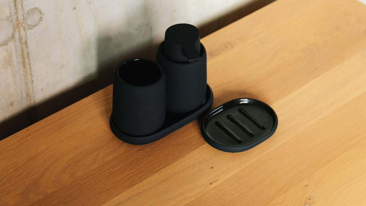 black soft touch bathroom accessories: soap dispenser, tumbler and dishes