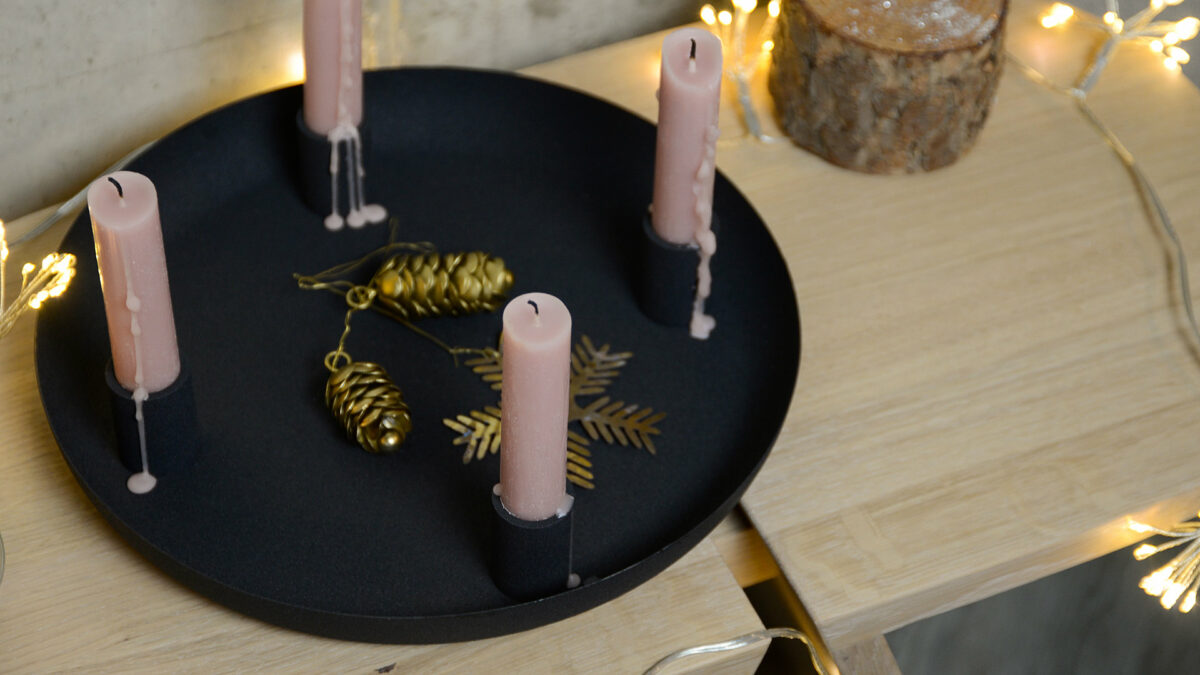 black bowl candle holder from above pink candles