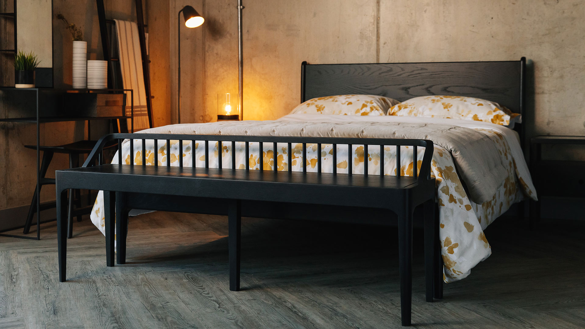 Cosy industrial style bedroom with Black oak furniture including a Camden bed and spindle bench