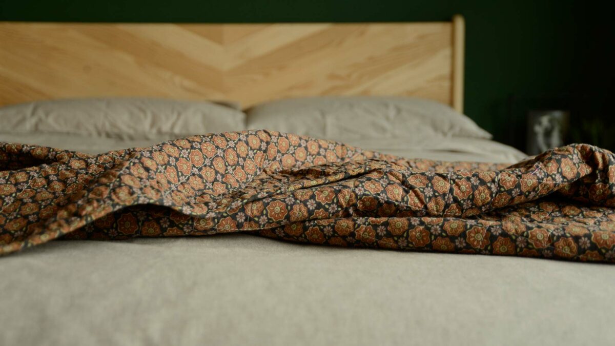 black cotton quilt with orange floral print