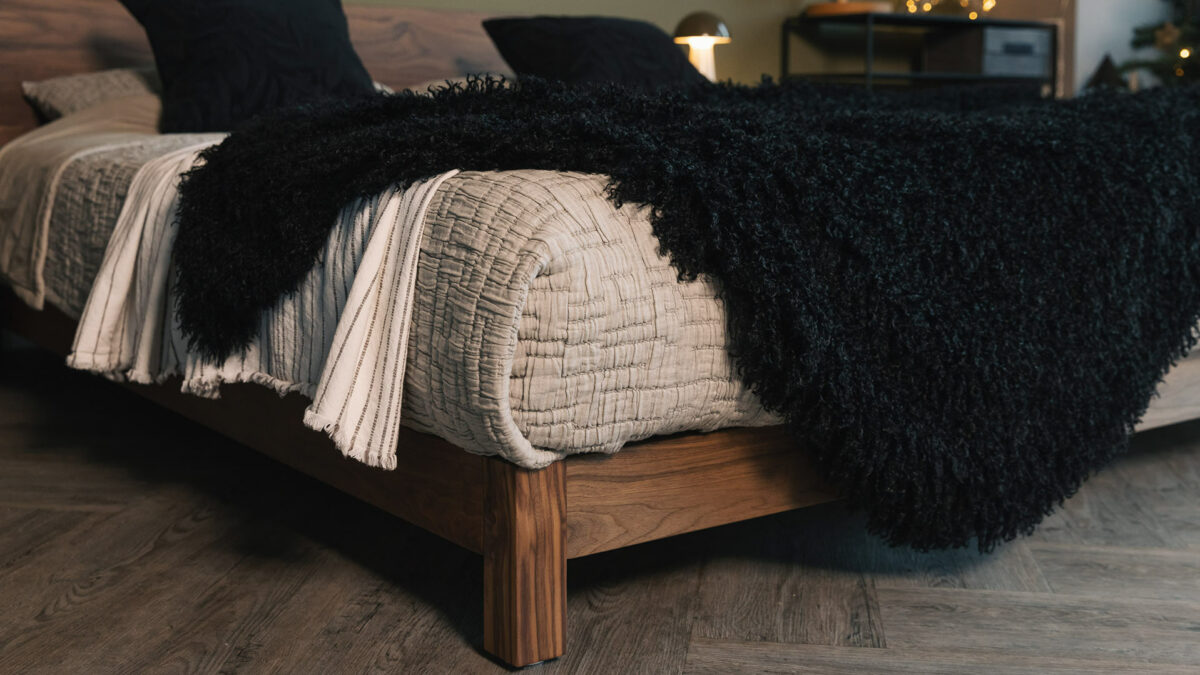 Walnut wood Superking Sonora bed shown with a black faux fur soft and curly throw