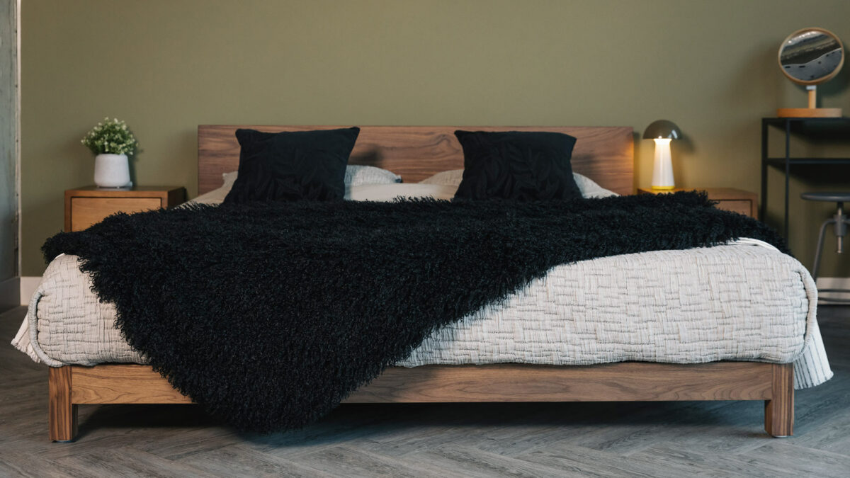 Walnut wood Superking Sonora bed shown with a faux fur soft black curly throw