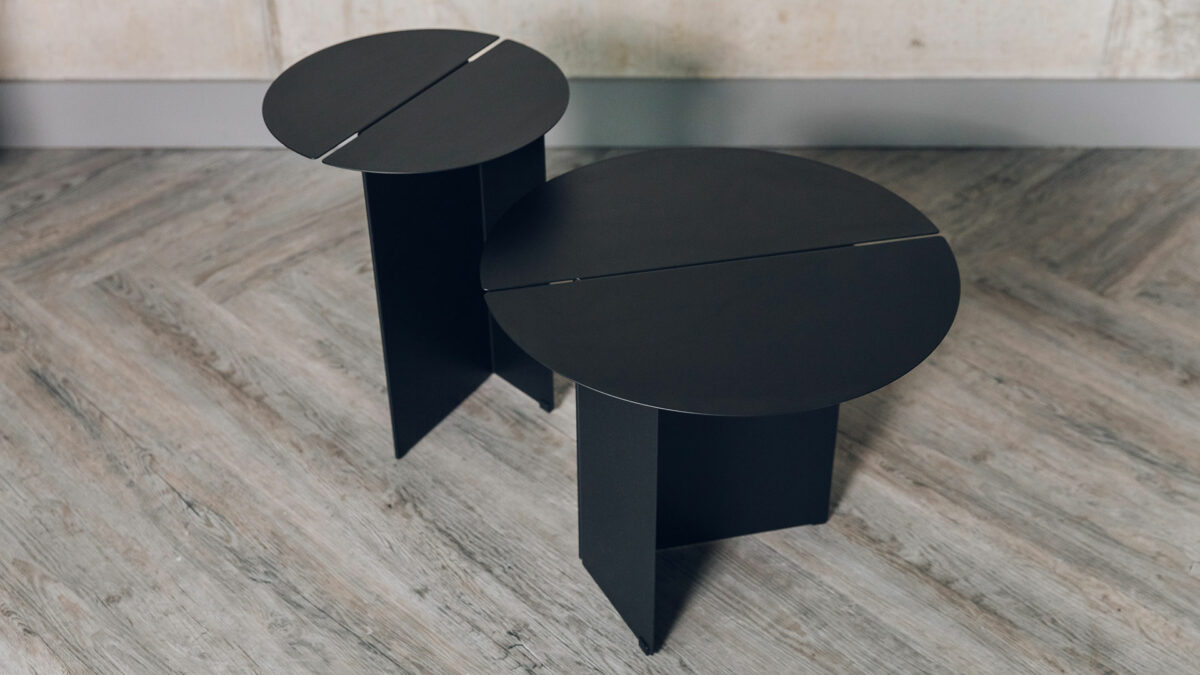 Bauhaus style black metal tables with slotted circular tops and in 2 sizes