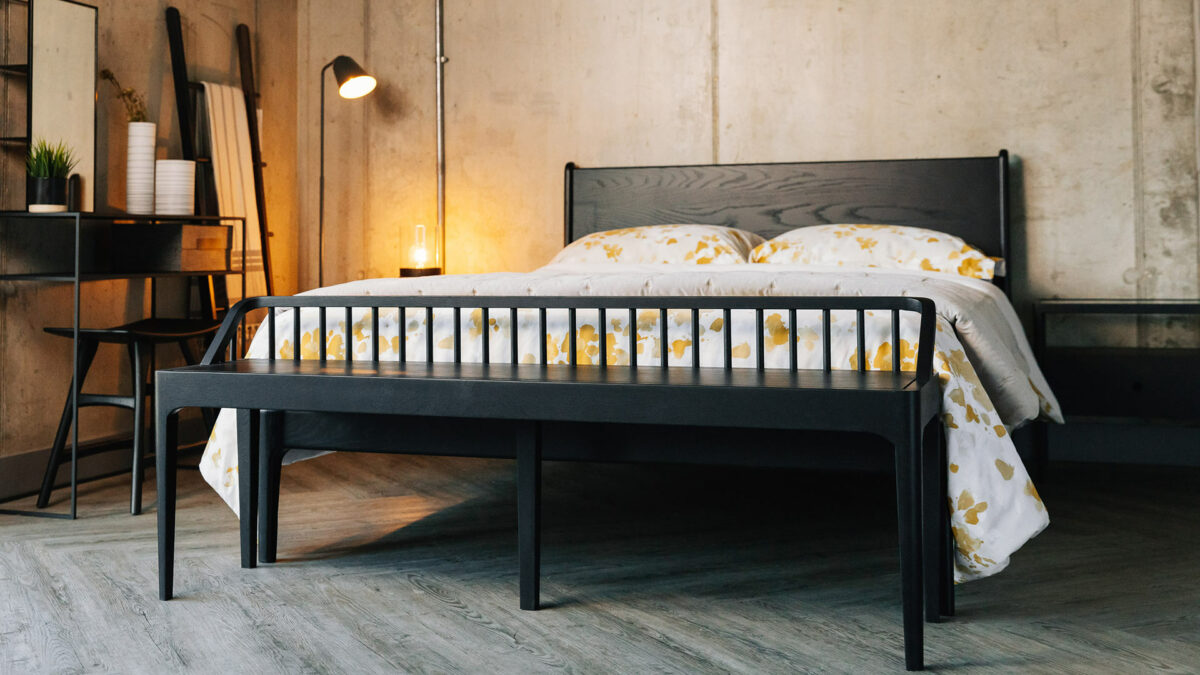 Industrial style bedroom with Black oak furniture including a Camden bed and spindle bench