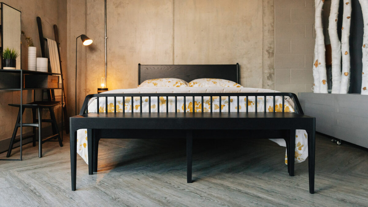 industrial style bedroom with Black oak furniture including a Camden bed and spindle bench