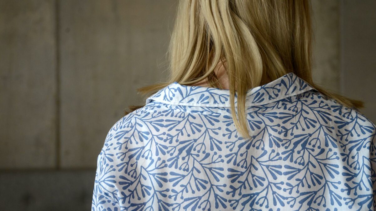 lightweight white cotton pyjamas with a block print leaf design in blue and shown from the back