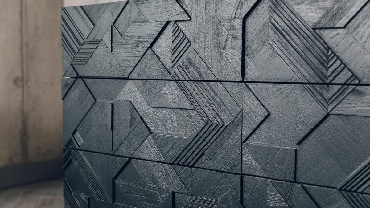 a closer view of the black carved graphic pattern to the 3 drawer storage unit by ethnicraft