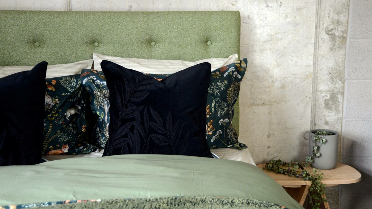 black velvet embroidered cushion leaf design on skye green bedding