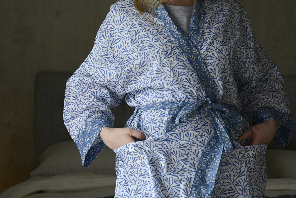 block print light cotton dressing gown with leaf print in blue and white shown on a model