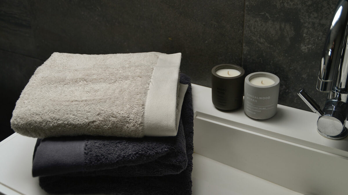 GOTS certified organic cotton towels in dark grey or pale clay