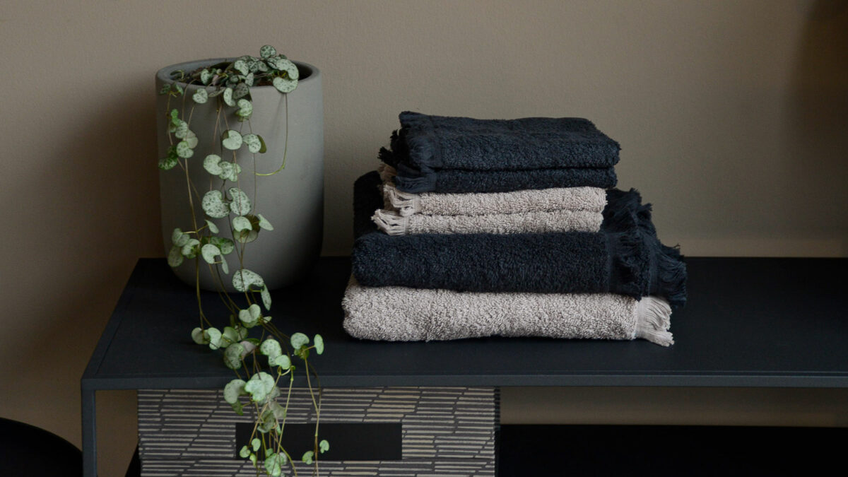 blomus tassle towels stone and charcoal stack with plant main view