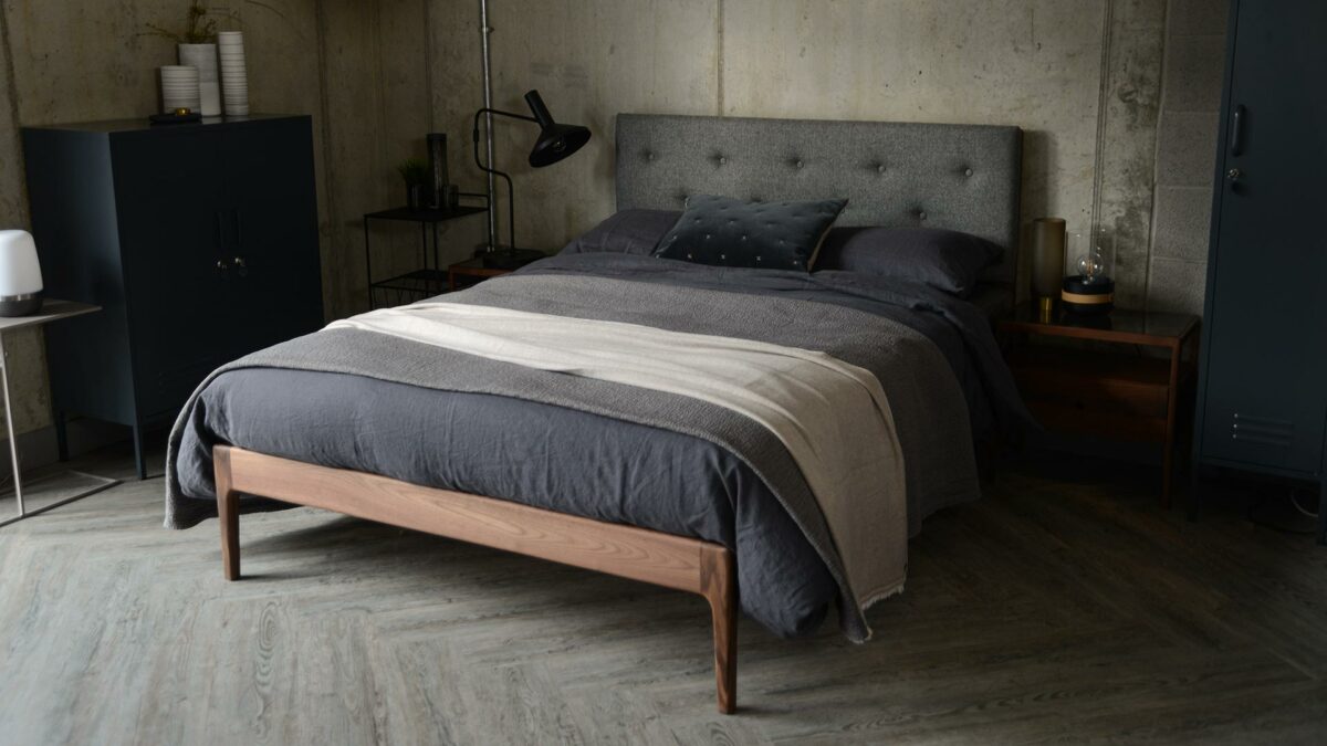 Scandinavian style bedroom featuring solid walnut framed Bloomsbury bed with grey upholstered headboard